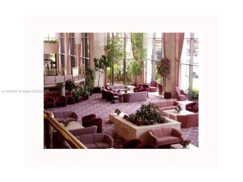 151 Southwest 134th Way, Unit 212N Pembroke Pines, FL 33027 - Photo 3 of 19 a picture of a living room with furniture and a large window