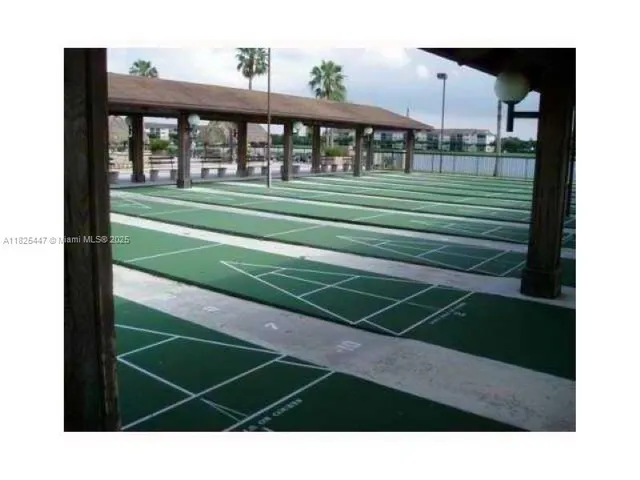 a view of a patio with a table and chairs under an umbrella