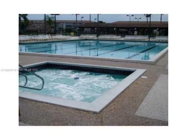 a view of a white house in front of a big yard