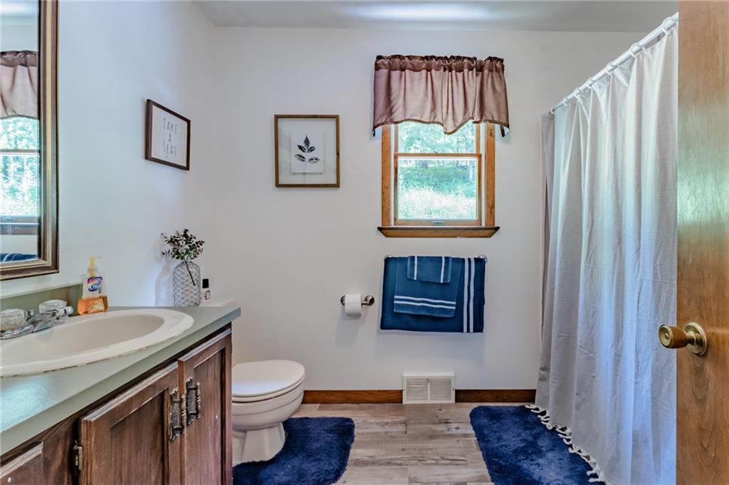 708 Margaret Road Kittanning, PA 16201 - Photo 20 of 25 a bathroom with a granite countertop sink a toilet and a mirror