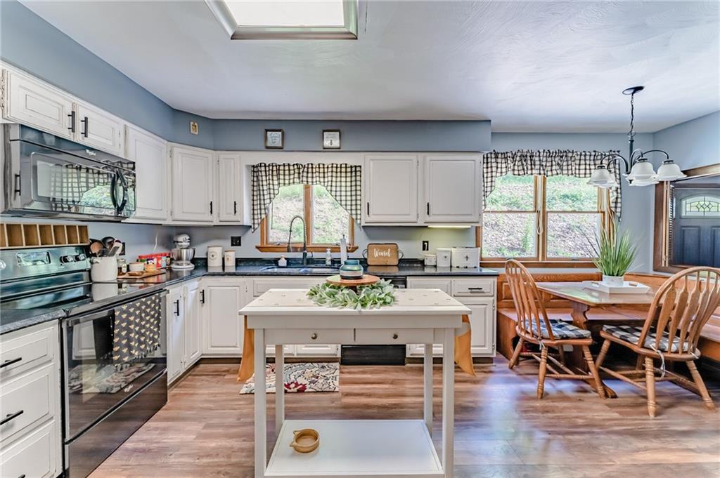 708 Margaret Road Kittanning, PA 16201 - Photo 6 of 25 a kitchen with stainless steel appliances granite countertop a stove top oven a sink dishwasher and cabinets with wooden floor
