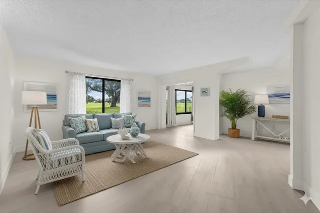 an empty room with window and wooden floor