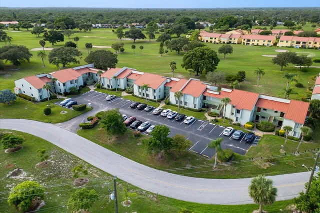 an aerial view of residential houses with outdoor space and swimming pool