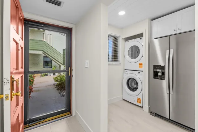 a utility room with sink dryer and washer
