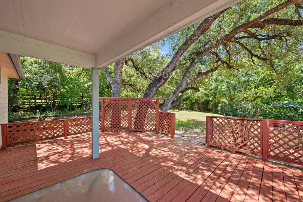 5208 Sioux Lane Austin, TX 78734 - Photo 35 of 35 A spacious covered deck offers a verdant backyard view, perfect for outdoor relaxation.