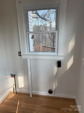 a view of an entryway with wooden floor
