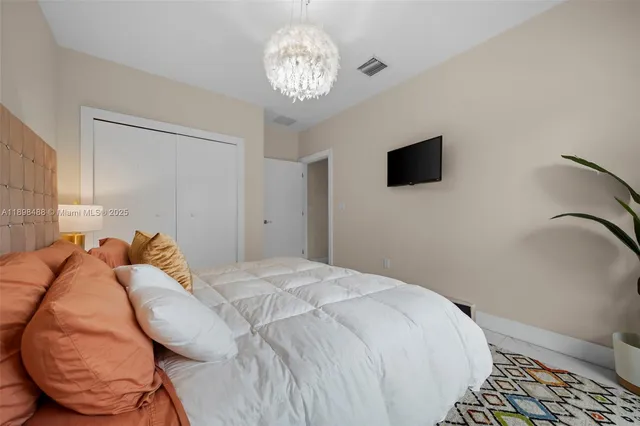 a bedroom with two beds and painted walls