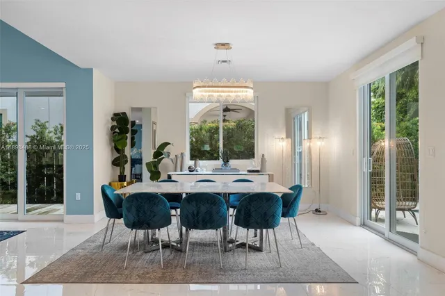 a large kitchen with kitchen island a dining table and chairs