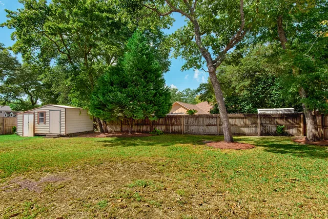 a view of a house with swimming pool and yard
