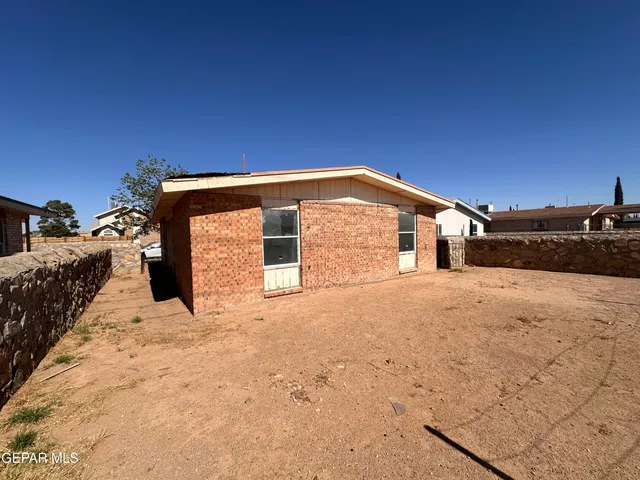 a view of a house with wooden fence