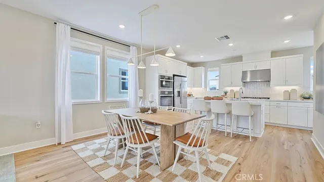 a kitchen with stainless steel appliances kitchen island granite countertop a sink and cabinets