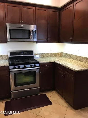 a kitchen with a stove and a microwave