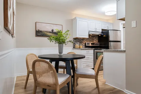 a dining room with furniture and wooden floor