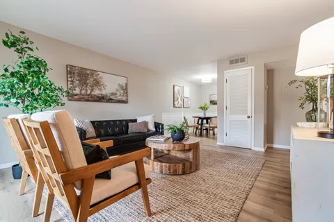 a living room with furniture and wooden floor
