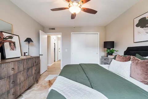 a bedroom with a bed and a chandelier