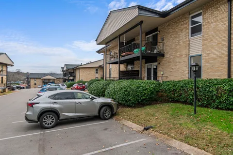a view of a car parked in front of a brick house