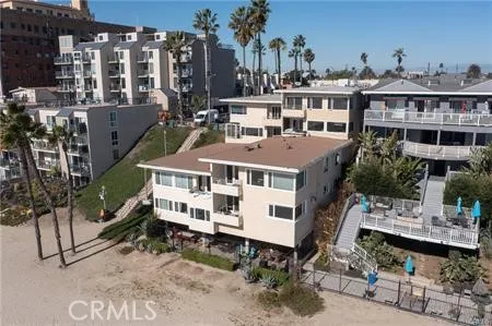 a aerial view of a house with a yard table and chairs