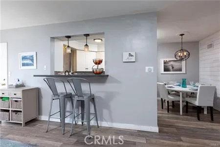 a dining room with wooden floor and glass door