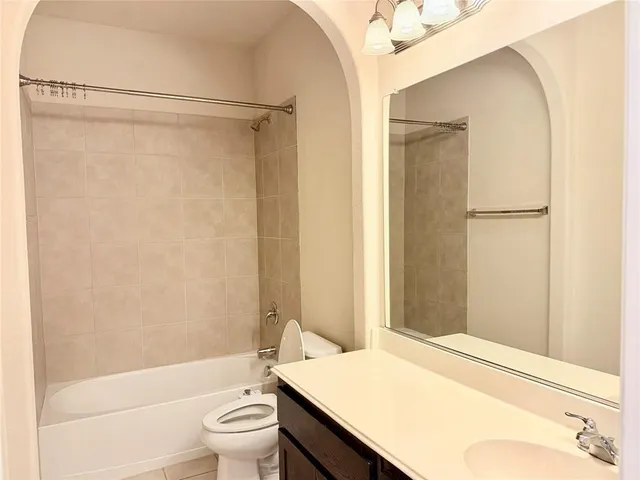 a bathroom with a sink a toilet and a shower