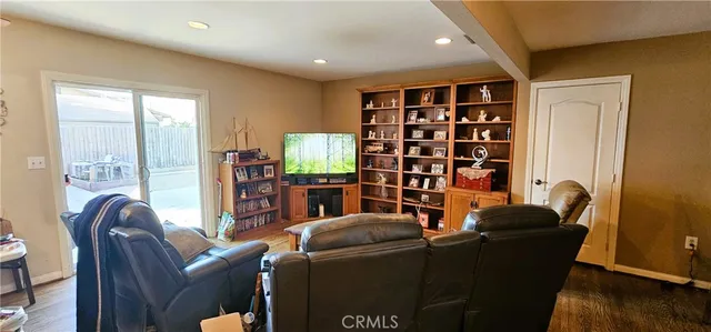 a living room with furniture and a book shelf