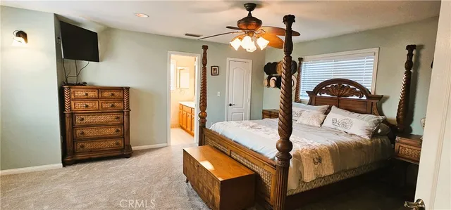 a bedroom with a bed and a mirror