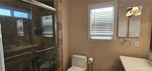 a bathroom with a toilet and a shower