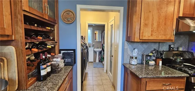 a kitchen with a refrigerator and a stove top oven