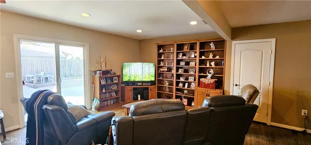 a living room with furniture and a book shelf