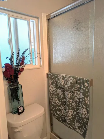 a bathroom with a toilet shower and a sink