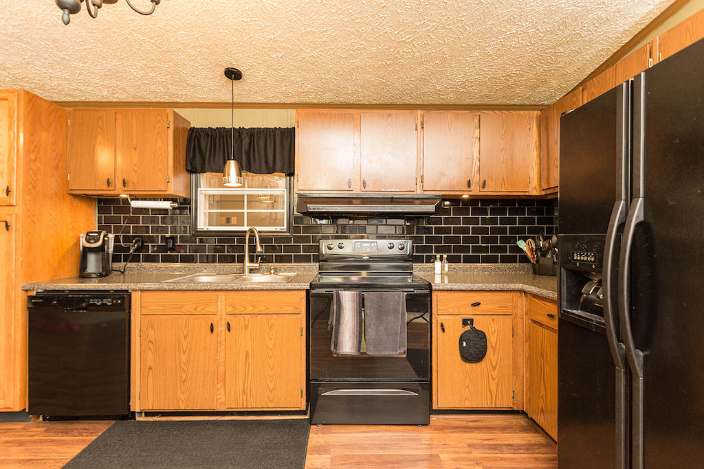 101 Crest Court Blue Ridge, VA 24064 - Photo 10 of 35 a kitchen with stainless steel appliances granite countertop a stove and a refrigerator