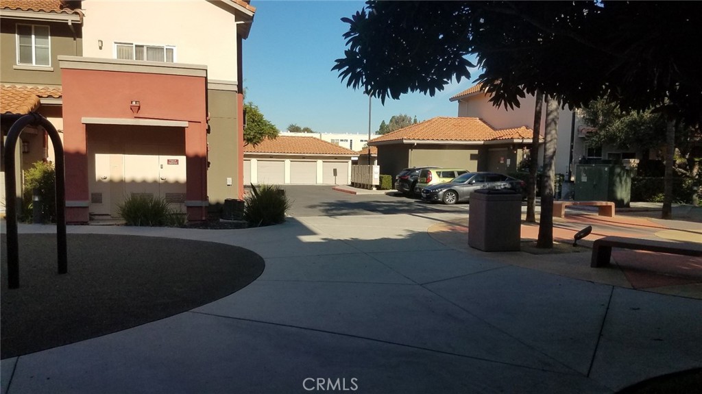 2177 Alum Rock Avenue, Unit 211 San Jose, CA 95116 - Photo 54 of 68 a view of a patio with table and chairs under an umbrella with a small yard
