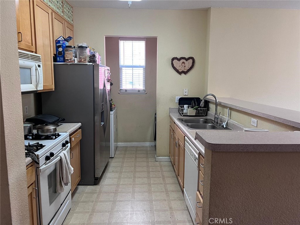 2177 Alum Rock Avenue, Unit 211 San Jose, CA 95116 - Photo 10 of 68 a kitchen with a sink stove and refrigerator