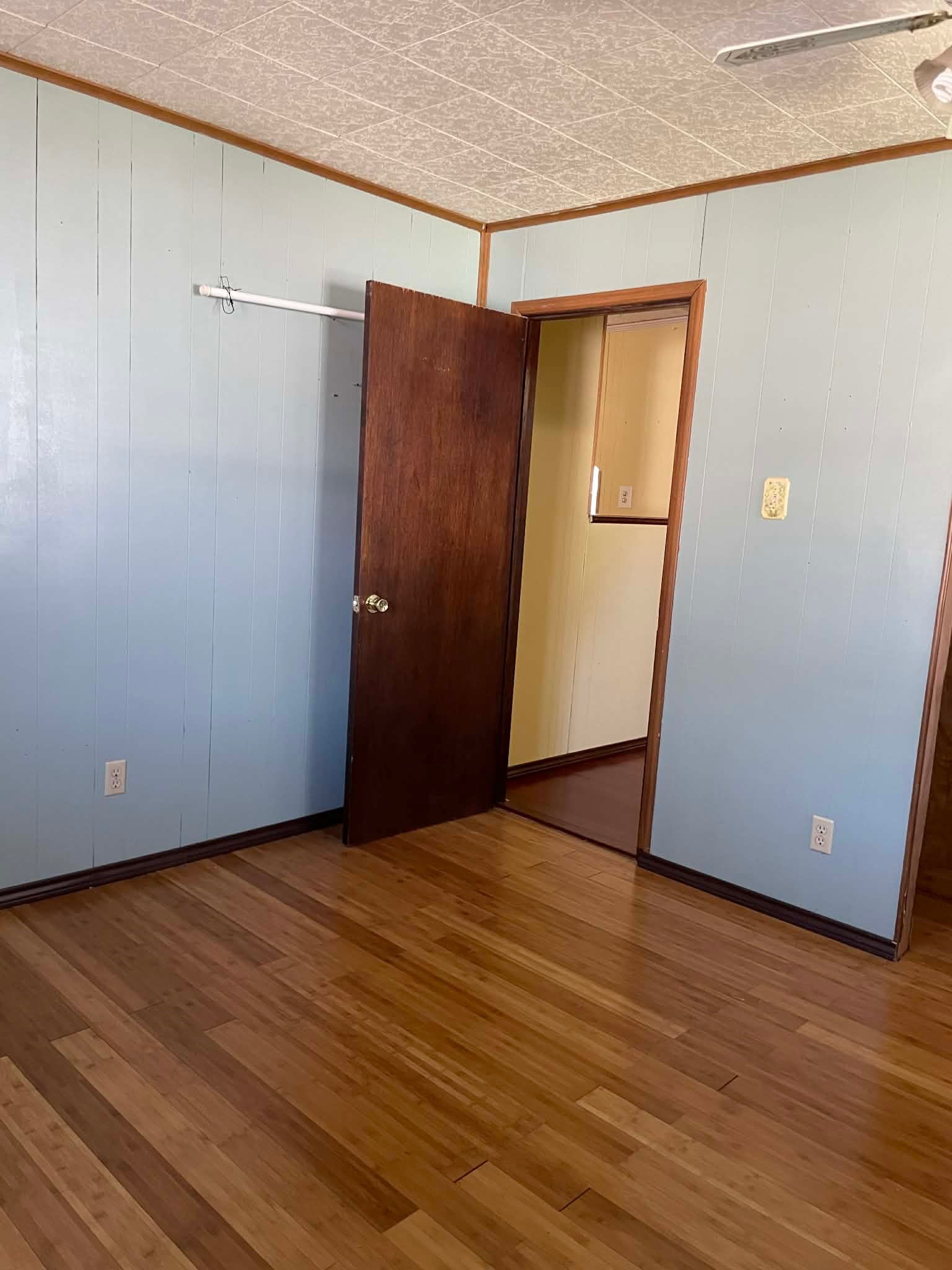 1825 Isom Street Houston, TX 77039 - Photo 21 of 27 a view of an empty room with wooden floor and a window