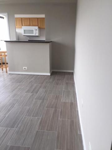 6030 North Sheridan Road, Unit 1207 Chicago, IL 60660 - Photo 2 of 10 a view of a room with wooden floor