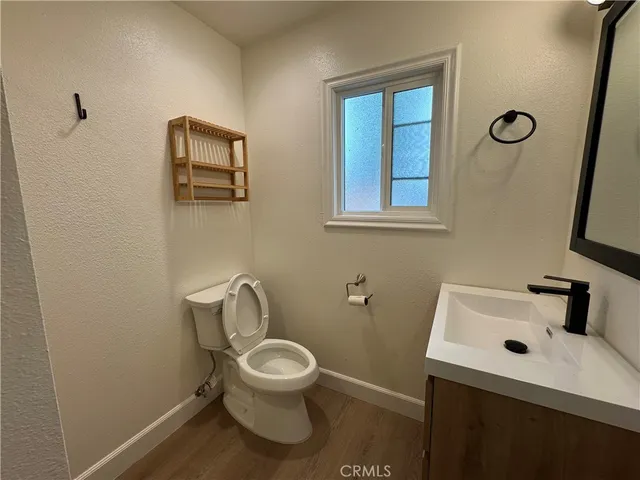 a white toilet sitting next to a bathroom sink