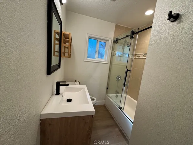 a bathroom with a sink toilet and shower