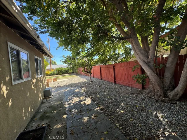 a view of a backyard with large trees
