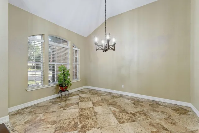 a view of a room with a chandelier and living room view