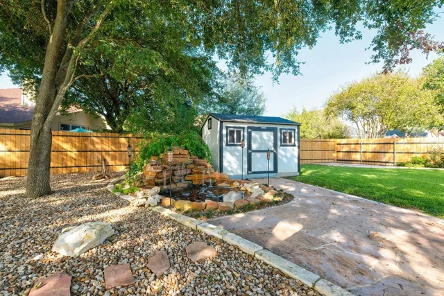 a view of a garden with a building in the background