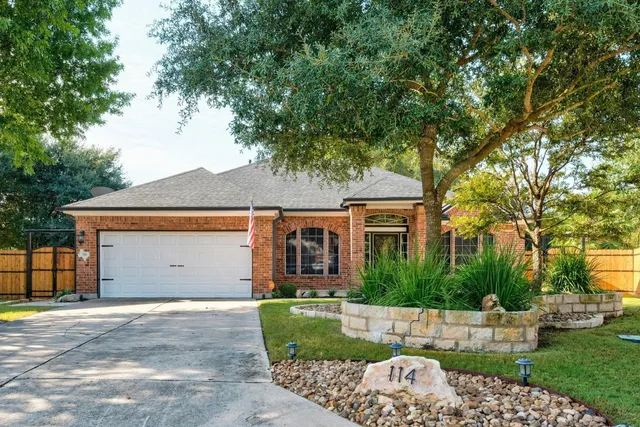 a front view of a house with a garden