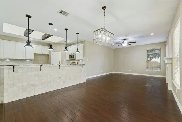 a kitchen with stove cabinets and wooden floor