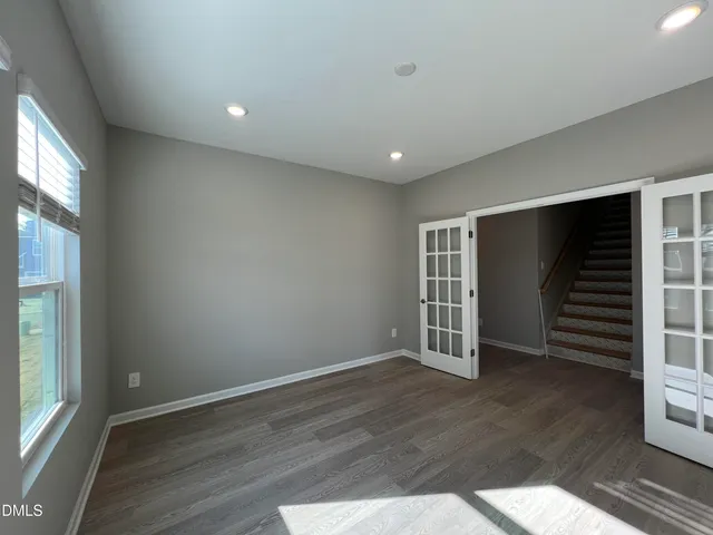 an empty room with windows and closet