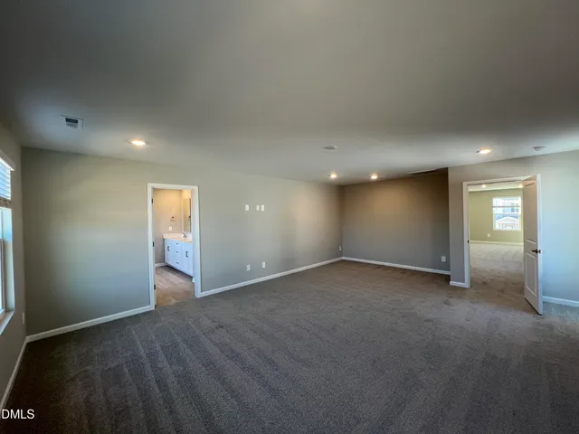 a view of an empty room and closet area