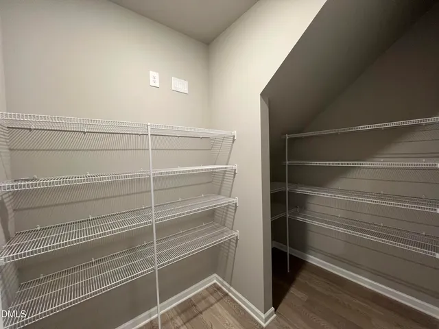 a bathroom with a toilet a sink a mirror and shower