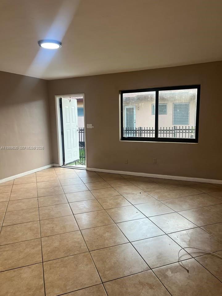 98 Northeast 71st Street, Unit 2 Miami, FL 33138 - Photo 3 of 9 a view of an empty room with a window