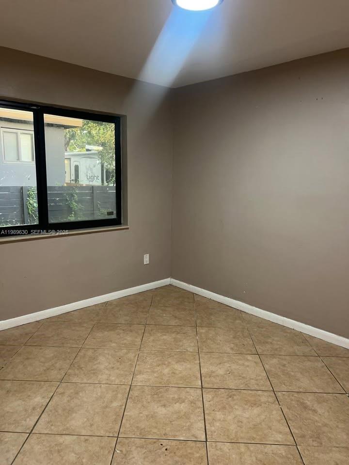 98 Northeast 71st Street, Unit 2 Miami, FL 33138 - Photo 7 of 9 a view of an empty room with a window
