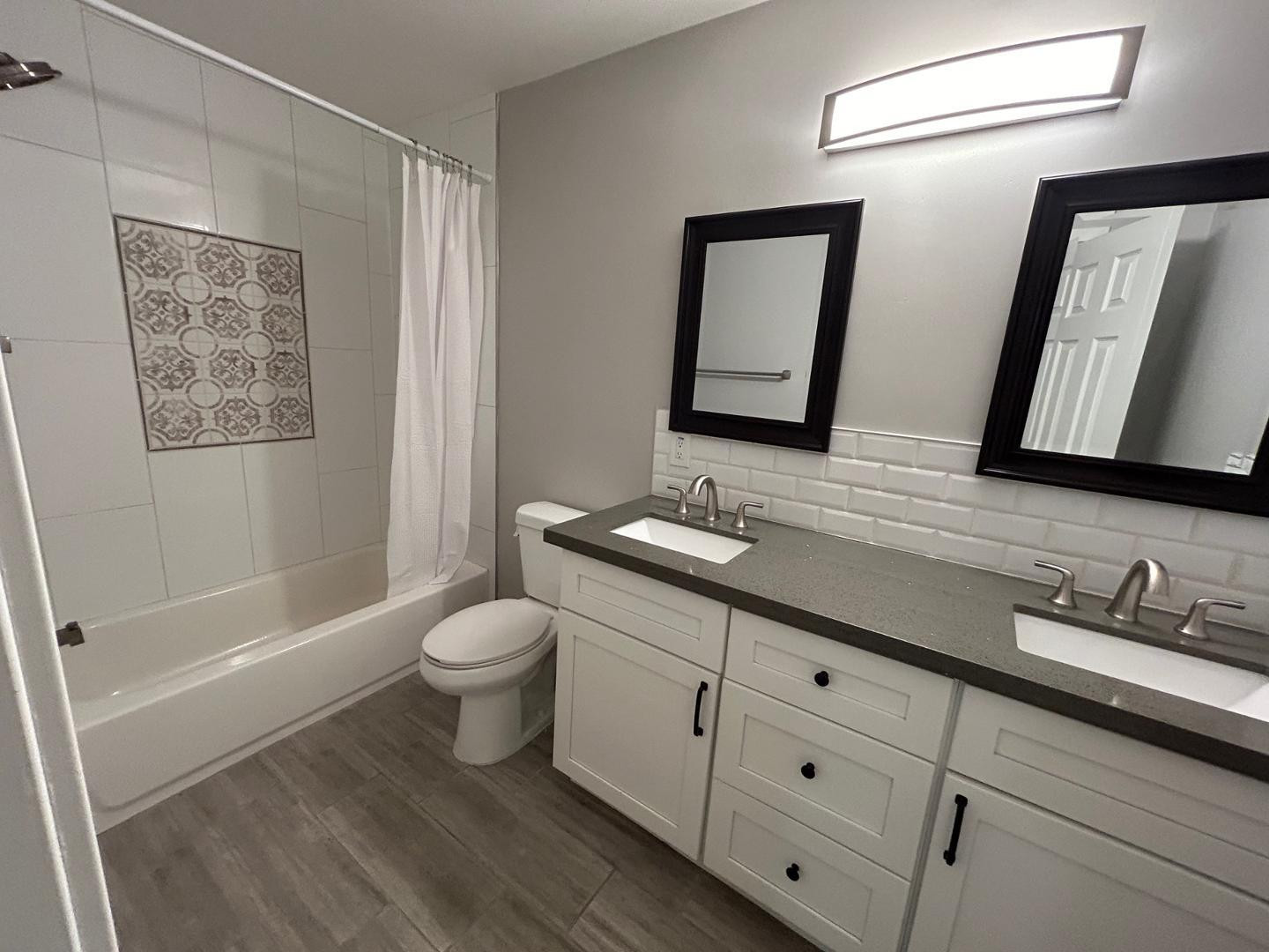 1117 West 9th Street Tempe, AZ 85281 - Photo 18 of 22 a bathroom with a double vanity sink a toilet and a mirror