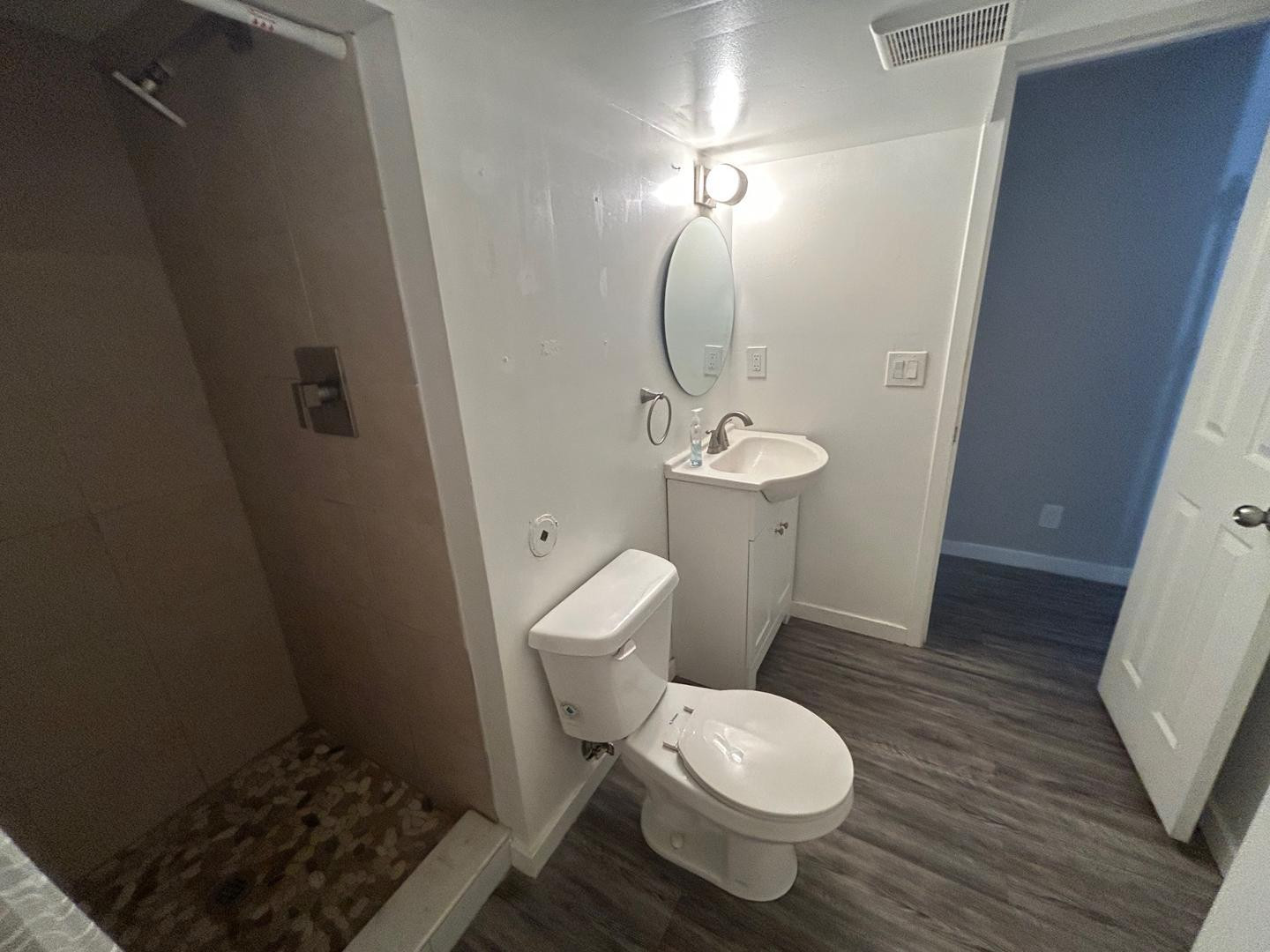 1117 West 9th Street Tempe, AZ 85281 - Photo 20 of 22 a white toilet sitting next to a sink and vanity