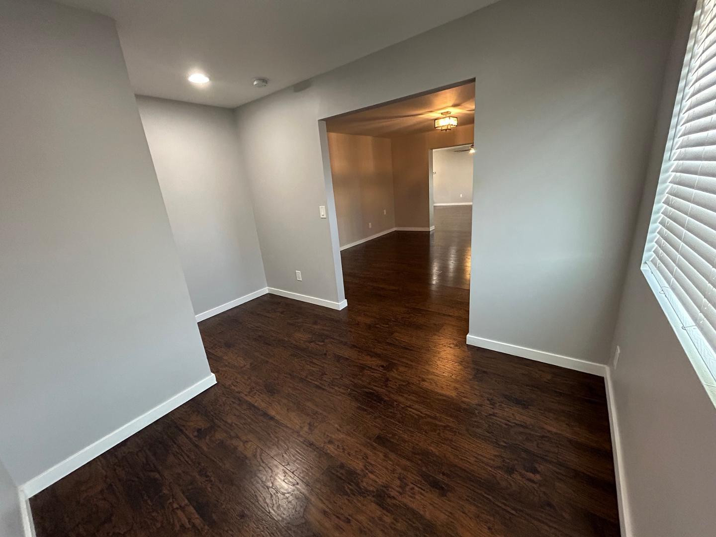 1117 West 9th Street Tempe, AZ 85281 - Photo 4 of 22 wooden floor in an empty room with a window