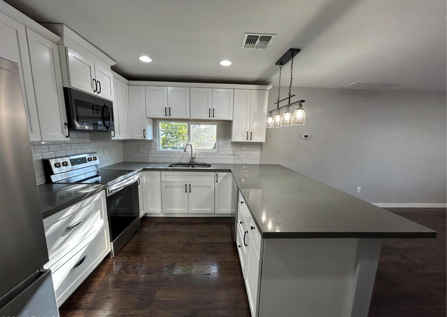 1117 West 9th Street Tempe, AZ 85281 - Photo 5 of 22 a kitchen with a sink stainless steel appliances and cabinets